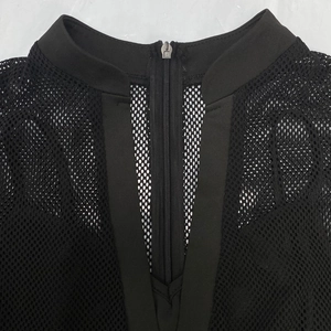 Detail shot of sheer black mesh bodysuit featuring a stand collar and front metal zipper