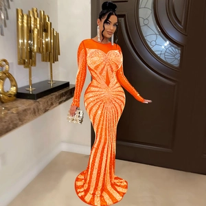 Detail of orange mesh evening gown with sparkling silver rhinestones and fishtail hem