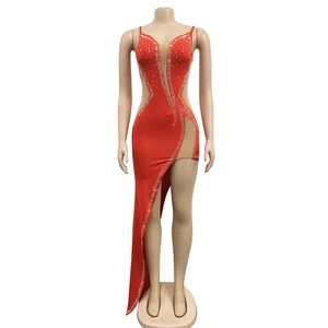 Detail of red rhinestone dress with sheer mesh inserts and asymmetric hemline