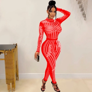 Detail of red long sleeve jumpsuit with sparkling rhinestone geometric patterns