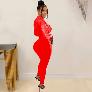 Detail of red mesh jumpsuit with rhinestones on long sleeves and body side seams