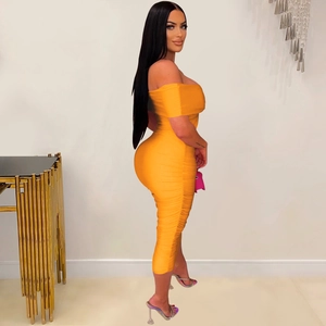 Detail view showing side ruched textures and slim fit of the orange tube midi dress