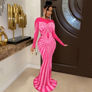 Close-up of sparkling silver rhinestones on a hot pink mesh evening gown with heart patterns