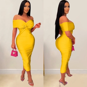Detailed close-up showing the pleated off-shoulder neckline and twist knot of the yellow dress