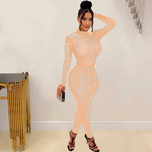 Detail of skin-tight jumpsuit featuring intricate white mesh lines and sparkling rhinestone texture