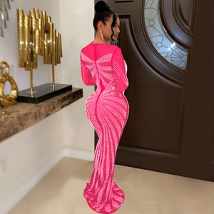 Close-up of bright pink mesh dress featuring intricate rhinestone butterfly patterns