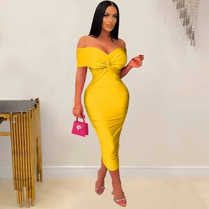 Detail of twist knot bodice and ruched texture on bright yellow midi tube dress