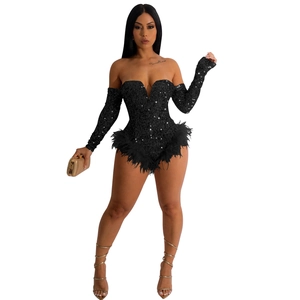 Detail of sequin jumpsuit with off-shoulder long sleeves and black feather trim details