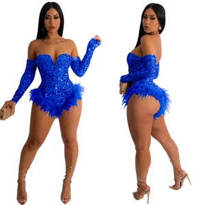 Close-up of royal blue sequined bodysuit with detachable sleeves and feather trim detail