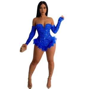 Detail of royal blue sequin romper with deep V-neck, long sleeves and feather trim edge