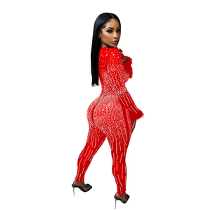 Detail view of red sequin jumpsuit with pearl beading and ostrich feather cuffs