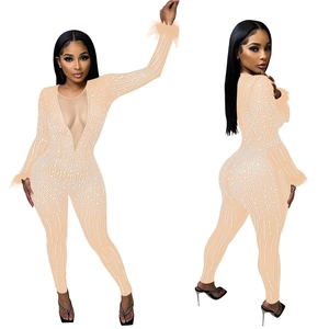 Flesh-toned jumpsuit featuring white pearls, deep V-neck mesh, and feather cuffs