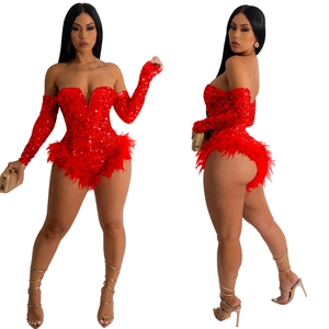 Detail of red sequin romper featuring an off-shoulder neckline and feather trim sleeve cuffs