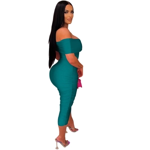Detail view of the side ruched texture and elastic fabric on this teal bodycon dress