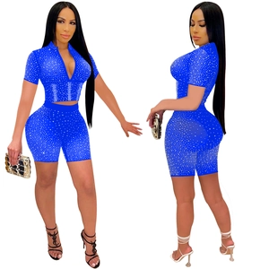 Macro shot of royal blue mesh crop top and shorts set featuring sparkling silver rhinestones