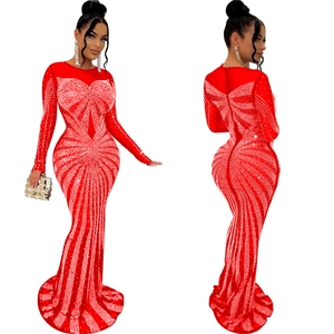 Detailed view of a red mesh evening gown with shimmering rhinestones and fishtail hemline