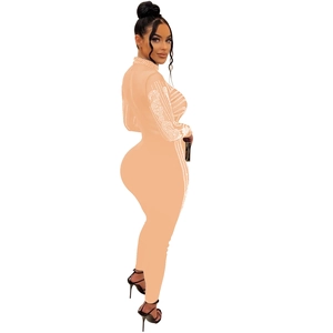 Detail of nude mesh jumpsuit featuring sparkling rhinestones and a slim-fit design