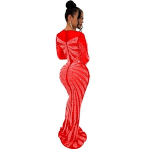 Close-up of red bodycon fishtail dress with elegant white rhinestone wing patterns