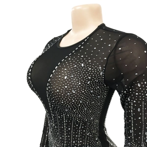 Detailed close-up of semi-transparent black mesh fabric with silver rhinestones