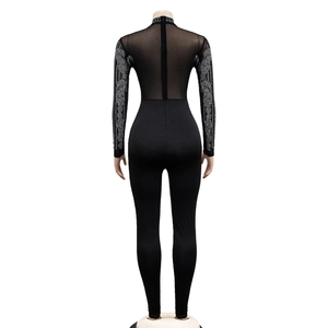 Close-up of black mesh jumpsuit back with sparkling rhinestones and invisible zipper