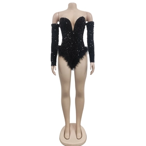 Detail of black sequined bodysuit featuring deep V-neck, feather hem and detached sleeves