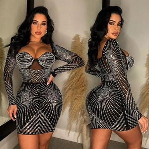 Detail of black mesh mini dress featuring silver rhinestones and sweetheart neckline