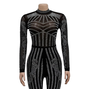 Detail of sheer black mesh bodysuit with sparkling silver rhinestones and geometric patterns
