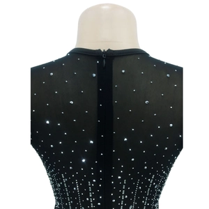 Close-up of black sheer mesh dress with silver rhinestones and a hidden back zipper