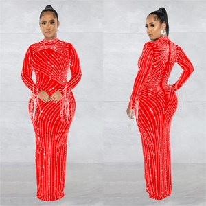 Detailed close-up of red sequined gown with rhinestones and long tassel sleeves
