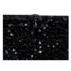 Detail of black sequined fabric featuring a high-quality invisible zipper closure