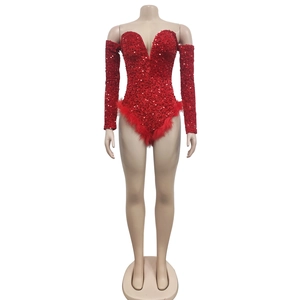 Close-up of red sequin romper with deep V-neckline and decorative feather trim detailing