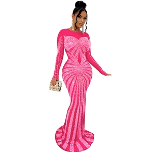 Detail of hot-drilled rhinestones and mesh patchwork on a pink long sleeve dress