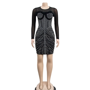 Detail of sheer mesh long sleeves with black feather trim and luxury rhinestone patterns