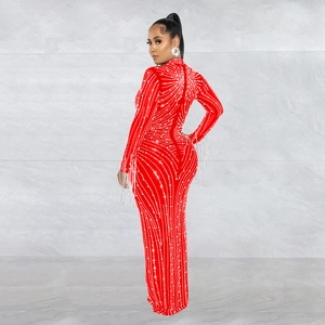 Detail of red mesh evening gown with sparkling rhinestones and elegant fringe sleeves