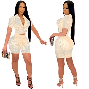 Detail of short sleeve mesh crop top and shorts set featuring all-over white rhinestones