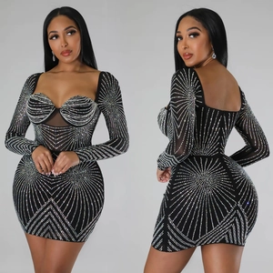 Detail of black mesh mini dress with radiant silver rhinestone patterns and slim fit
