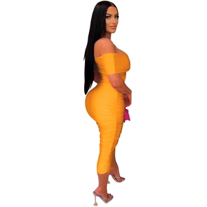 Detail of orange strapless dress showing ruched side texture and elastic slim fit