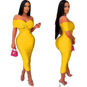Detail of yellow strapless dress showing twisted bust design and ruched bodycon texture