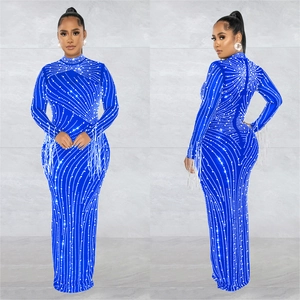 Detail of royal blue mesh dress with radiant rhinestones and fringed sleeve cuffs