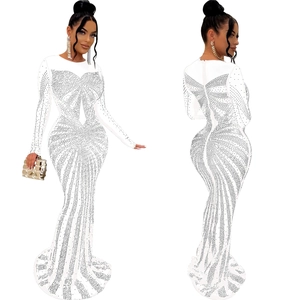 Detail of white long sleeve evening gown with radiant rhinestones and mesh patchwork