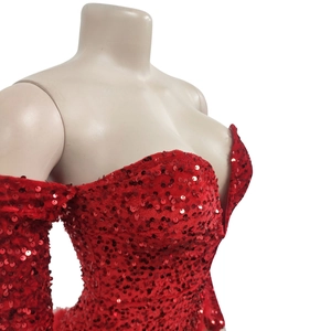 Detailed close-up of red sequin fabric on deep V-neck long sleeve cocktail dress