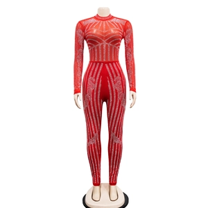Detail of red mesh jumpsuit featuring sparkling rhinestones and a mock neck design