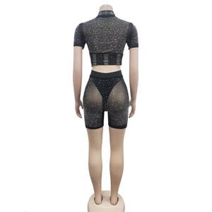 Rear view of black mesh two-piece set featuring sheer fabric and sparkling rhinestones