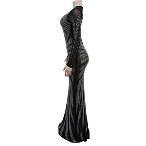 Detailed view of black mesh evening gown featuring intricate silver rhinestone fringe patterns