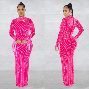 Detail of hot pink evening gown with rhinestone wave patterns and fringe sleeve cuffs