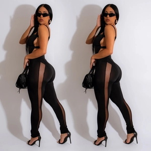 Sleek black jumpsuit featuring sheer mesh side panels and stylish cut-out details