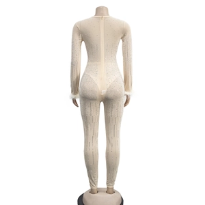 Detailed back view of mesh jumpsuit featuring sparkling rhinestones and white feather cuffs