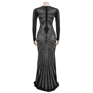 Detail of silver rhinestones in radial geometric patterns on black mesh dress fabric