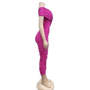 Detail view of ruched texture and cross-front design on rose red bodycon dress
