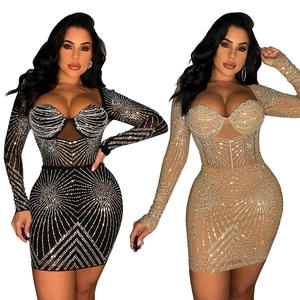 Detailed close-up of mesh long sleeve dress with luxury rhinestone starburst patterns